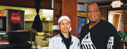 Ray Aker (right) and his sushi chefs, including Ceu Hrang (left), combine the flavors of barbecue and sushi.