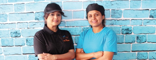 Annie Khan (left)  and her sister Nina (right) work together in their restaurant OMG Burger.