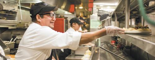 Garland resident Antonio Oreste, 42, works two jobs at The Shops at Legacy, including this one as a cook at Taco Diner.