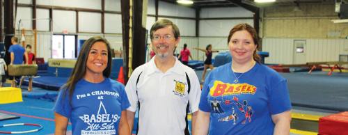 Office Manager Anna Spencer (left), owner John Basel and Business Manager Kristen Basel run the gymu2019s business.