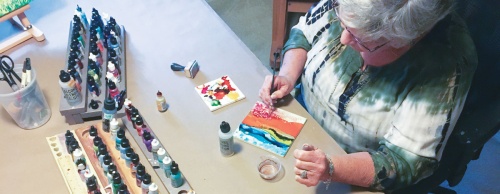 It typically only takes McDougall about 20 minutes to apply alcohol ink to each of her creations before the tiles are treated with torched resin. 