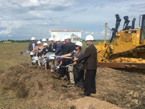 Officials from the city of Pflugerville, the Pflugerville Community Development Corp., the Pflugerville Chamber of Commerce and Flooring Services Southwest break ground on a new facility for the company.