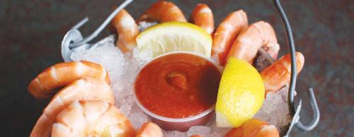 Peel u2018n Eat Shrimp ($7.99 per half dozen, $12.99 per dozen) is served with lemon wedges and cocktail sauce.