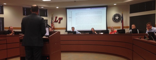 Members of the Lake Travis ISD board of trustees discuss bond ballot language at a meeting July 18.