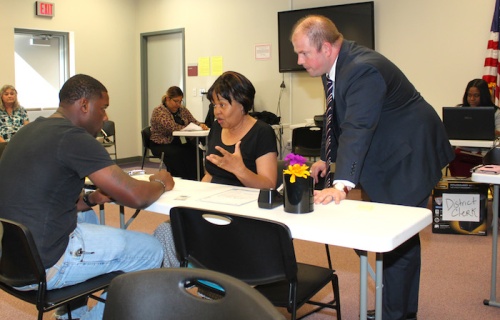 Harris County District Clerk Chris Daniel (right) oversees the passport application process at a satellite office in Humble.