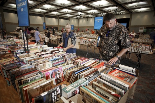 Attendees sort through books at a previous sale. 