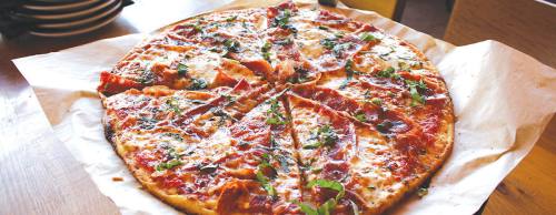 The Beeu2019s Knees ($16) is topped with a spicy red sauce, mozzarella and basil.