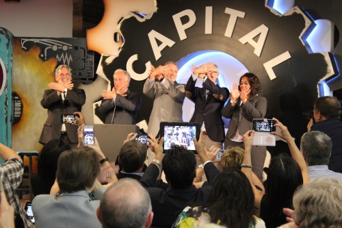From left: Austin Mayor Steve Adler, state Sen. Kirk Watson, ACC President Richard Rhodes, Apple CEO Tim Cook and ACC IT employee Keelee Moseley do the hand sign for the Riverbat, ACC's mascot.