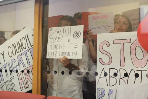 Citizens hold signs at San Marcos City Council protesting Senate Bill 4, also known as the sanctuary cities bill.