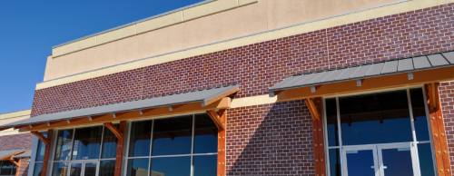 Why do corporate logos on signs appear differently in some parts of town?