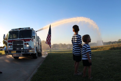A firetruck hose sprays a field during a 9/11 memorial service hosted by the Frisco Garden Club. The service commemorated the 15th anniversary of the terrorist attacks of Sept. 11, 2001.