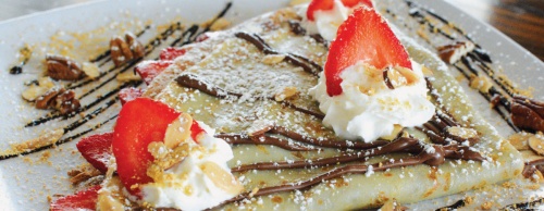 Vivel serves sweet crepes topped with almonds, walnuts, Nutella, whipped cream and strawberries.