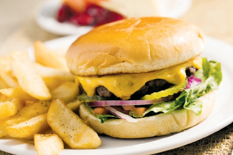 Cheeseburger ($8.99)nThis burger is made with an 8-ounce, hand-pressed beef patty topped with cheese, mustard, mayonnaise, lettuce, tomato, onions and pickles. It is served with a side of french fries.