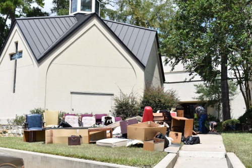 Volunteers pulled damaged furniture and items out of Cypress Creek Christian Church on Cypresswood Drive on Thursday.