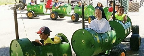 Attendees of the Santa Cruz Holy Cross Festival enjoy carnival rides. 