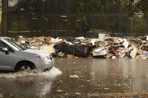 Water remains on a street below the Barker Reservoir dam in Houston on Monday, Sept. 18, 2017.