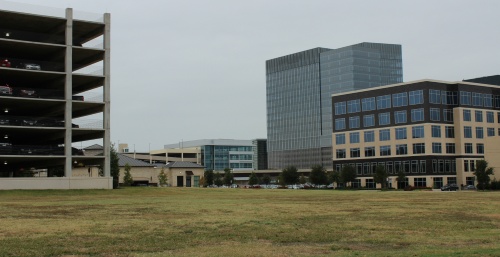 A set of grassy fields in the heart of The Shops at Legacy in Plano are the proposed sites for two new office towers.