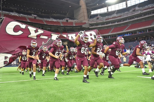 The Cy-Fair High School football enters the field during its Class 6A Division II state semifinal playoff against Austin Westlake on Dec. 16 at NRG Stadium. The Bobcats beat Westlake 14-6 to advance to its first-ever state championship game.