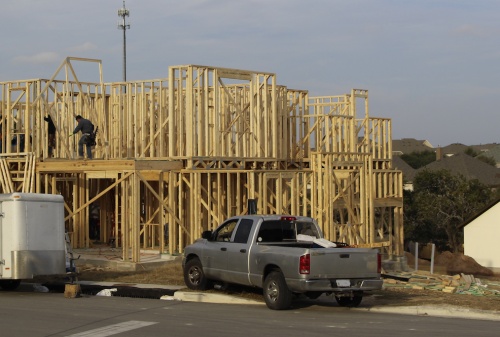 Framers work on a new home in the Sweetwater West community in western Travis County. 
