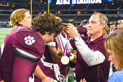 CFISD Director of Athletics Ray Zepeda presents championship medals to the Cy-Fair High School football team on Dec. 23. 