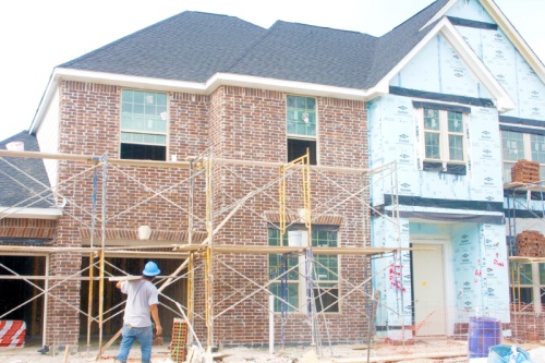 Crews work on a new home at Hidden Arbor, a Trendmaker Homes community in Cypress.