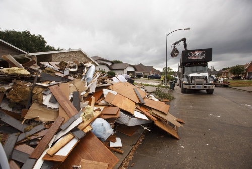 Debris from Harvey flooding is removed from a Port Arthur neighborhood on Wednesday, Sept. 20, 2017.