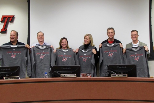 From left: Lake Travis ISD trustees Bob Dorsett Jr., John Aoueille, Kim Flasch, Lisa Johnson, Alex Alexander and William Beard pose Jan. 23 with shirts received for School Board Recognition Month.