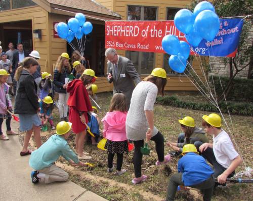 Pastor Tom Grevlos watches as children help break ground at Shepherd of the Hills Lutheran Church Jan. 28.