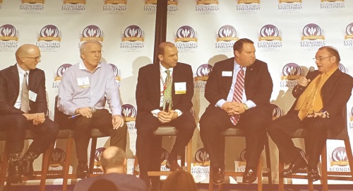 Michael Overstreet, Philip Schneidau, Richard Ehlers, Lance Schielack and Ray Perryman speak on a panel at the West Houston Economic Development Summit. 