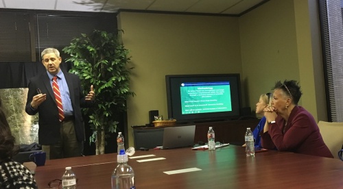 Christopher Sallese, left, discusses storm surge protection at a recent Houston Northwest Chamber of Commerce meeting.