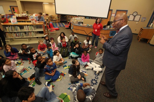 Spring ISD Superintendent Rodney Watson greets students receiving book donations.