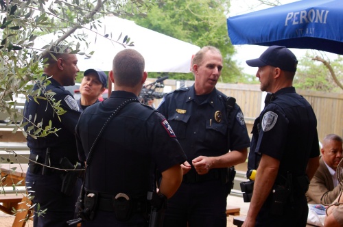 Sunset Valley Police Chief Lenn Carter (left)  speaks with other law enforcement officers March 28.