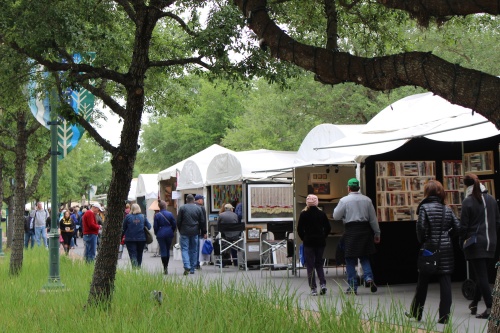 Visitors walk past artists' booths at a previous festival.