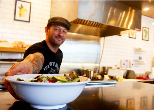 Owner Sebastien Caillabet serves a Green Goddess Cobb Salad with a hard-boiled egg, bacon, blue cheese, chicken, tomatoes and housemade dressing. 