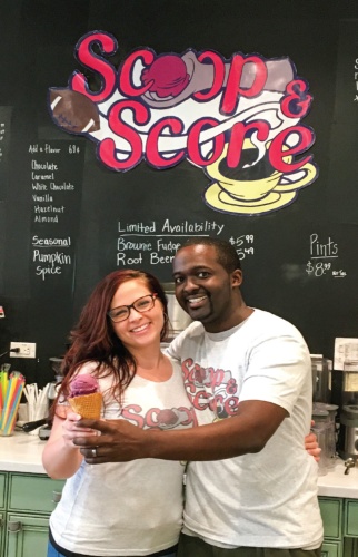 Alex and Angela Ellis hold out two scoops of Graeteru2019s Black Raspberry Chocolate Chip ice cream. 