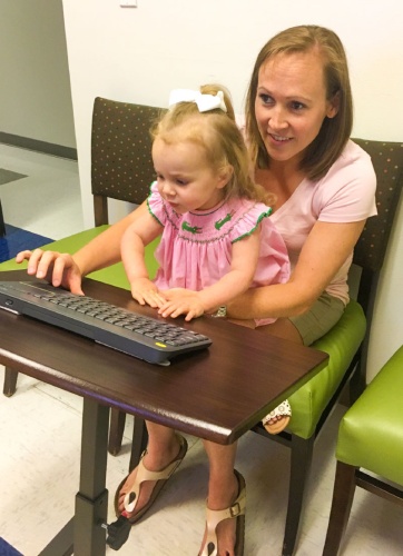 Leander resident Mary Kathryn Allen and her daughter engage with a doctor at the Urgent Care for Kids telepod.