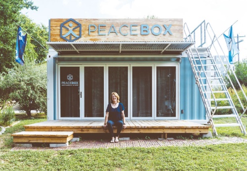 Stacy Thrash, founder of PeaceBox, sits with one of her two mobile meditation studios that travel to schools, businesses and events in the Greater Austin area. 