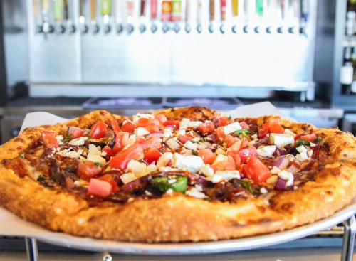 The Wrangler pizza includes smoked brisket on a barbecue-sauce base with red onions, jalapenos and pico tomatoes, topped with feta cheese and Sriracha. The pizza costs $19 for a medium or $26 for an extra large. 