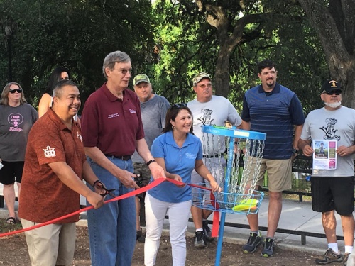 Community members gathered July 14 to celebrate enhancements to the city's nine-hole disc golf practice course, which were funded by the Tri-County Disc Golf Club. 