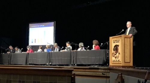 Dr. Richard Rhodes, president of Austin Community College, speaks alongside members of the ACC board of trustees during a public hearing at Pflugerville High School on Monday, July 9. 