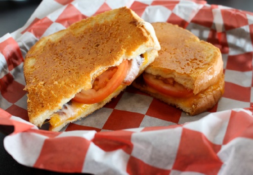 The Tom+Chee melt ($7.99) contains Wisconsin cheddar cheese, mozzarella, Roma tomatoes, balsamic reduction and garlic seasoning served on parmesan-crusted sour-white bread.