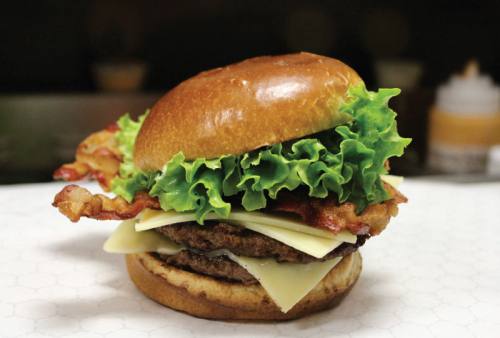 The Great White Cheddar Burger, one of Sharks Burgersu2019 offerings, includes bacon, cheese and two patties.
