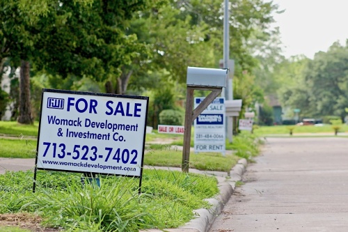 Sale and lease signs line a street in Friendswood. Some homes affected by Hurricane Harvey are returning to the market after being renovated.
