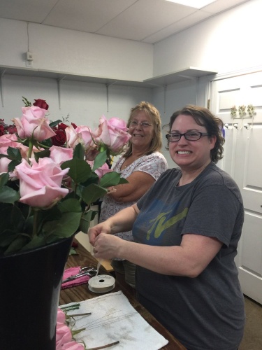 From left: Paula White-McAuley works at Wildflower Blessings Floral Designs as a designer and delivery person, and Heather Olson is a master florist at the shop.