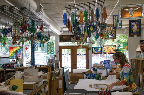 Blue Moon Glassworks is tucked among the homes in the Hyde Park neighborhood; local artists display their work in the shopu2019s street-facing picture windows.