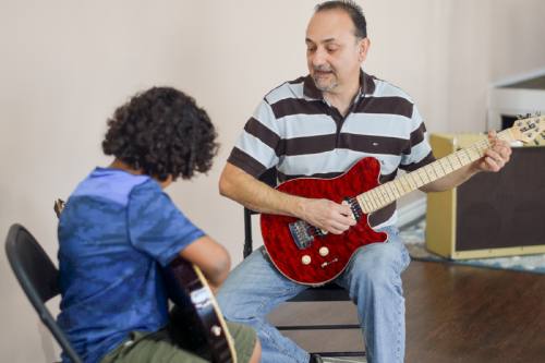 Armando Rodriguez (right) founded 6 Strings Music Academy in 2005 and relocated the business to House & Hahl Road in Cypress in 2016.