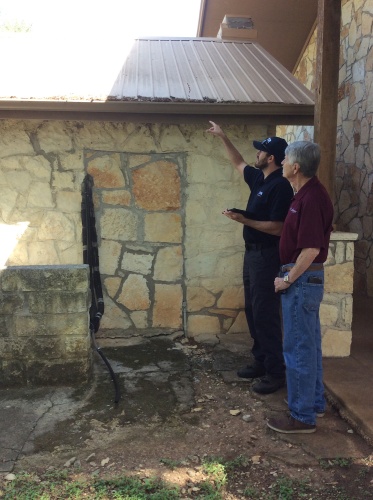 Chris Rea, wildfire mitigation specialist at Lake Travis Fire Rescue, evaluates the Lakeway Heritage Center's defensible space against the threat of wildfire with Lakeway Archivist Mike Boston.