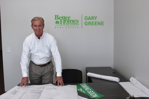 Manager David Johnston poses at Gary Greene's new League City Better Homes and Gardens Real Estate office.