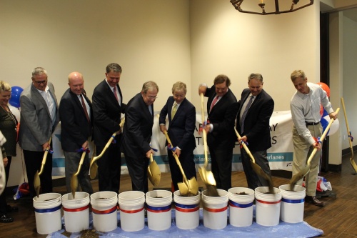 Officials with the I-635/SH 121 interchange project turn shovels for the groundbreaking.