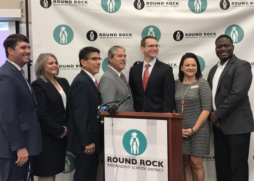 (From left) Trustee Mason Moses, Board of Trustees President Diane Cox, Superintendent Steve Flores, Sen. Larry Taylor, Commissioner Mike Morath, Trustee Nikki Gonzales and Trustee Edward Hanna gather to announce Round Rock ISD's accountability rating.